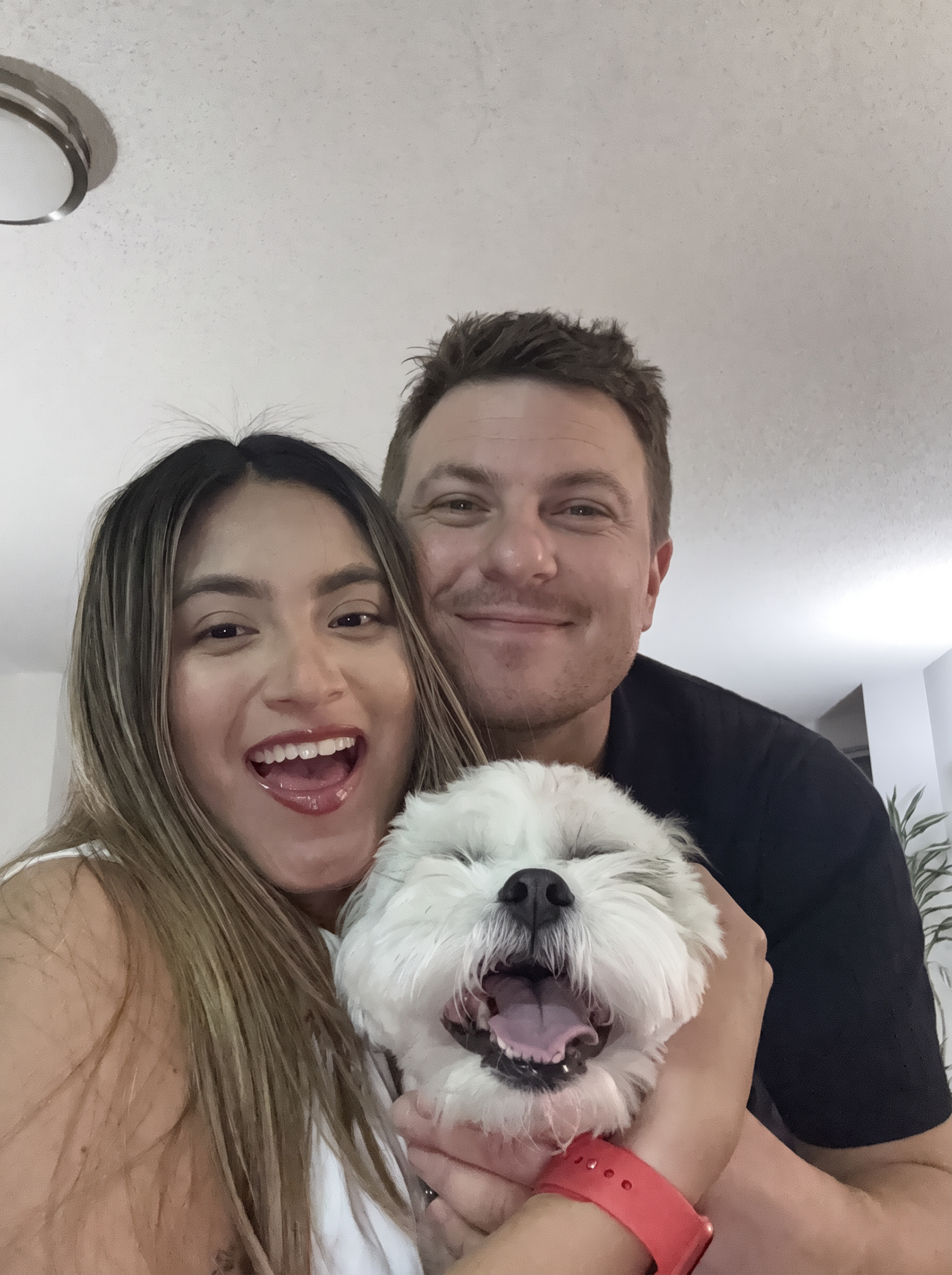 The pawrents behind Pawfect Care holding their dog Tobby